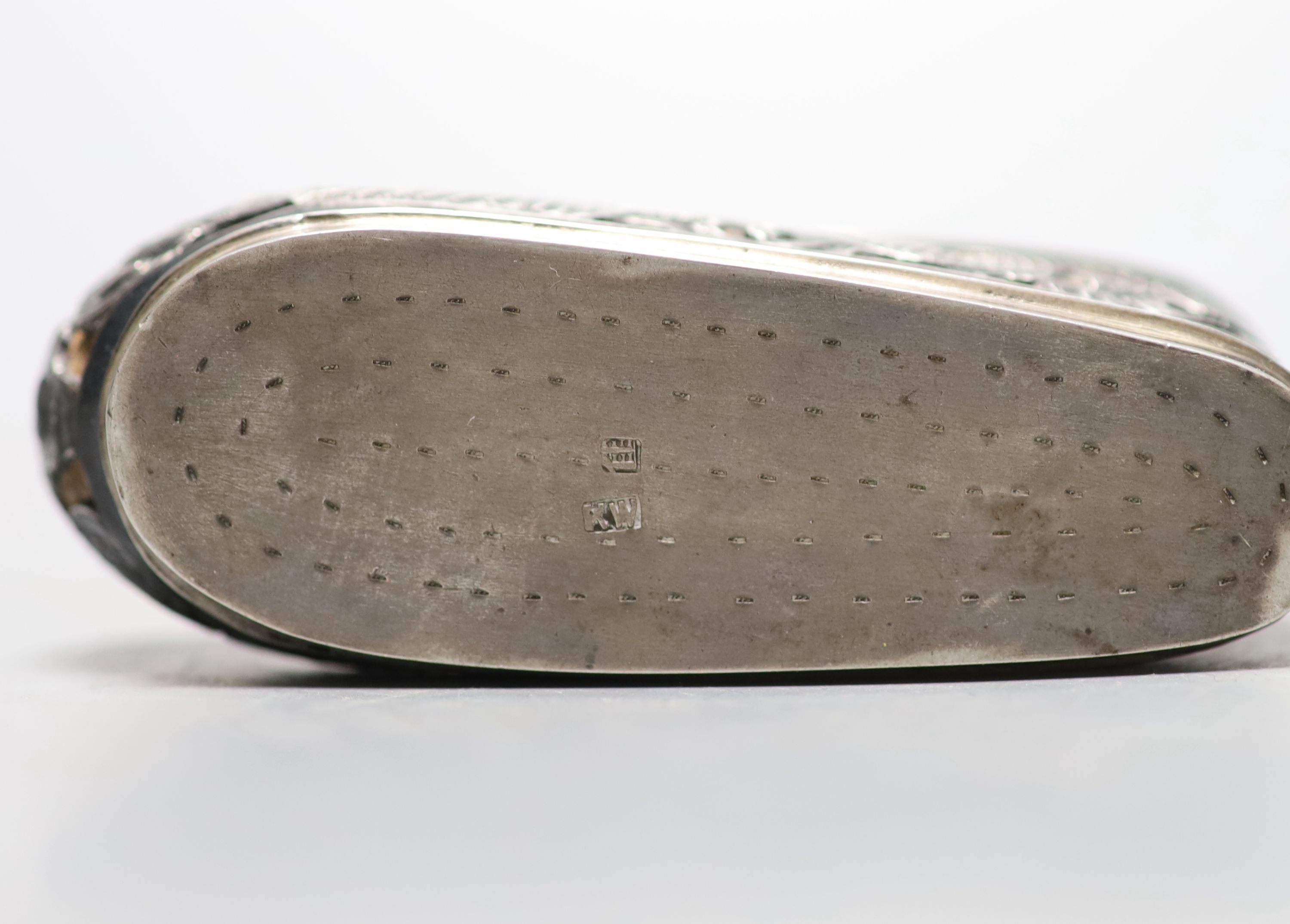 An early 20th century Chinese pierced white metal pin cushion, modelled as a shoe, maker KW, 81mm.